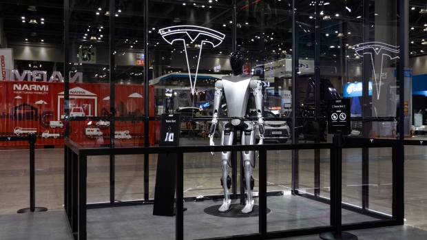 A mockup of Tesla Inc.'s planned humanoid robot Optimus on display during the Seoul Mobility Show in Goyang, South Korea, on Thursday, March 30, 2023. The motor show will continue through April 9. Photographer: SeongJoon Cho/Bloomberg