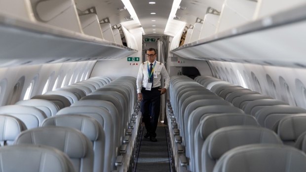 The business class cabin inside an Embraer SA E195-E2 Profit Hunter aircraft during the Singapore Airshow in Singapore, on Tuesday, Feb. 20, 2024. Aircraft delivery delays, the uphill battle of going green by 2050 and elevated airfares that increasingly make flying the domain of the wealthy — all these topics and more will be in focus this week as executives from over 1,000 companies descend on Singapore for Asia's most influential aerospace and defense exhibition. Photographer: SeongJoon Cho/Bloomberg