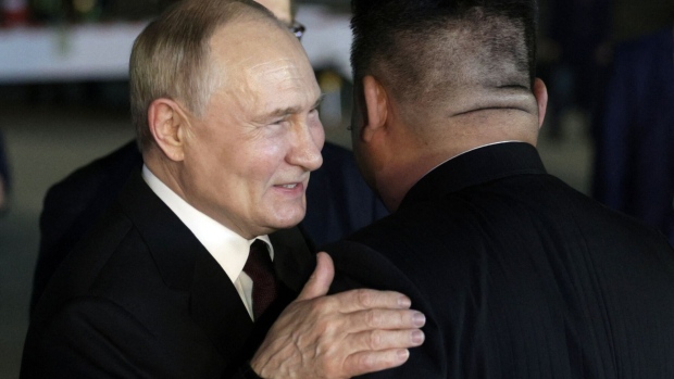 Kim Jong Un, right, greets Vladimir Putin upon Putin’s arrival in Pyongyang, early on June 19. Photographer: Gavriil Grigorov/AFP/Getty Images