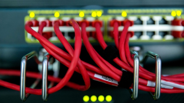 Cables run into the back of a server unit. Photographer: Krisztian Bocsi