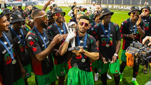 Red Star FC's players celebrate with the French National Championship trophy on May 18. Photographer: Antonin Utz/AFP/Getty Images