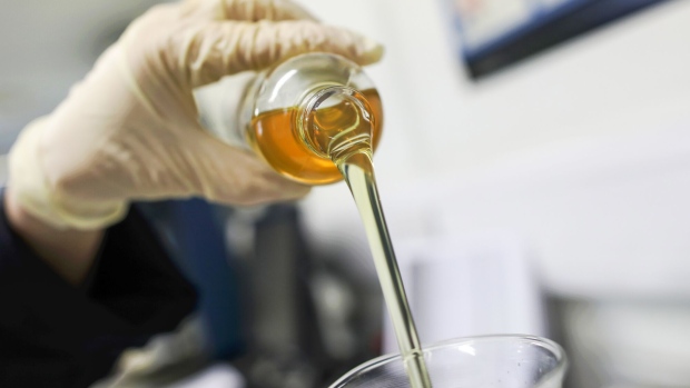 <p>An employee pours an oil based lubricant.</p>