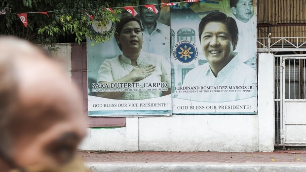 Posters featuring Sara Duterte-Carpio, Philippines' vice president, left, Ferdinand Marcos Jr., Philippines' president, on a wall in Manila, the Philippines, Oct. 22, 2023. The Philippine central bank may raise its key interest rate as early as this week, according to central bank Governor Eli Remolona, in what may be viewed as a preemptive signal amid expectations of significant price gains. Photographer: Veejay Villafranca/Bloomberg