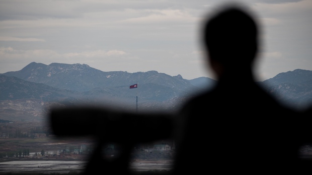 A North Korean flag flying over North Korea's Gijungdong village is seen from the Dorasan Observatory in the Demilitarized Zone (DMZ) in Paju, South Korea, on Tuesday, April 24, 2018. The leaders of the two Koreas are set to hold their first summit since 2007 on April 27, and officials are taking a series of diplomatic steps to lay the ground for the historic meeting. Photographer: SeongJoon Cho/Bloomberg