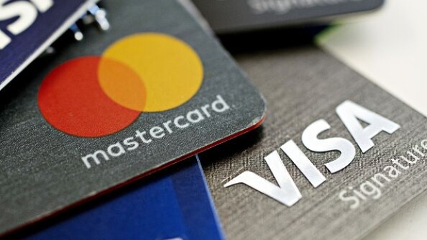 Visa Inc. and Mastercard Inc. credit cards are arranged for a photograph in Tiskilwa, Illinois, U.S., on Tuesday, Sept. 18, 2018. Visa and Mastercard agreed to pay as much as $6.2 billion to end a long-running price-fixing case brought by merchants over card fees, the largest-ever class action settlement of an antitrust case. Photographer: Bloomberg/Bloomberg