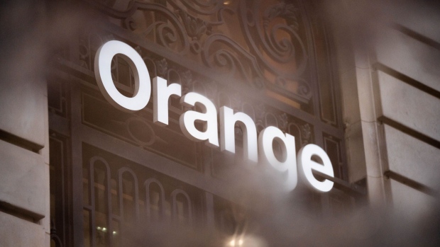 A logo outside the Orange SA Opera boutique store in Paris, France, on Wednesday, April 26, 2023. Orange reported sales in line with its 2023 targets and just below analyst estimates in the first quarter, as a price increase to counter inflation led to a slight increase in the number of mobile customers who left the French carrier. Photographer: Nathan Laine/Bloomberg