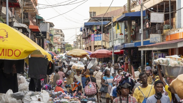 Shoppers make their way through Makola market in Accra, Ghana, on Monday, March 11, 2024. Ghana is resisting calls by holders of the country's eurobonds to offer a sweetener for restructuring $13 billion of debt, risking a self-imposed deadline for a deal. Photographer: Ernest Ankomah/Bloomberg