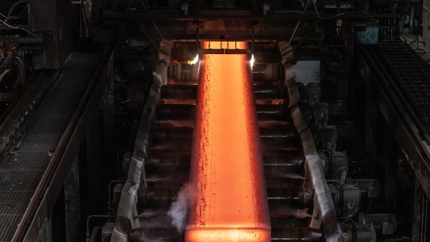 A red hot steel slab rolls off the cutting machine at the end of the continuous casting line at the Tata Steel Ltd. plant in IJmuiden, Netherlands, on Monday, June 5, 2023. The Tata factory in IJmuiden is making communities grapple with the question of what to do when an economic lifeline also threatens public health. Photographer: Peter Boer/Bloomberg