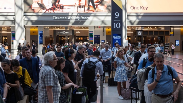 <p>Commuters wait for an Amtrak train in Moynihan Train Hall at Penn Station in New York on Tuesday, June 18. </p>