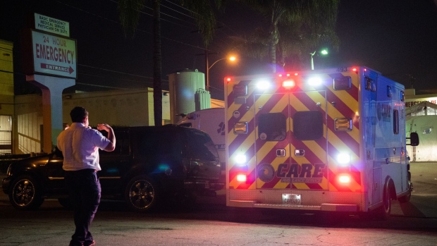 <p>An emergency medical technician directs an ambulance outside the emergency room of the East Los Angeles Doctors Hospital in Los Angeles, California.</p>