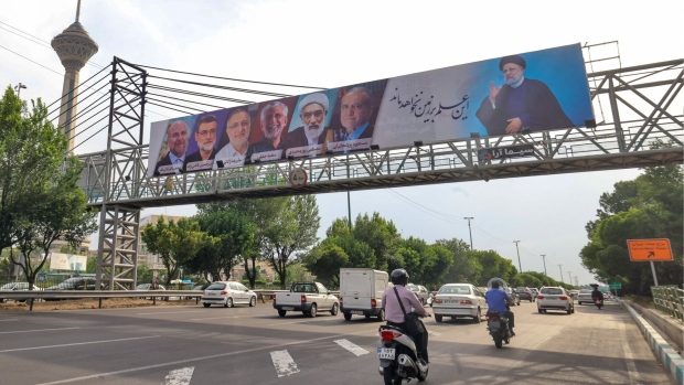 A billboard showing the six candidates running in the upcoming Iranian presidential election, in Tehran. Photographer: Atta Kenare/AFP/Getty Images