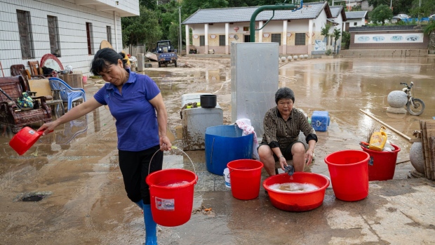 Villagers try to clean their houses following flooding due to heavy rainfall in Meizhou, Guangdong Province on June 23. Photographer: John Ricky/Anadolu/Getty Images