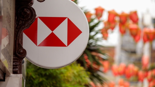 A HSBC logo sits on a sign outside a HSBC Holdings Plc bank branch in the Chinatown district of London, U.K., on Monday, July 27, 2020. The Treasury is in talks with the U.K.'s largest banks about a plan to tackle billions of pounds of bad debts expected under the government's Coronavirus loans program for small businesses, the Financial Times reported. Photographer: Jason Alden/Bloomberg