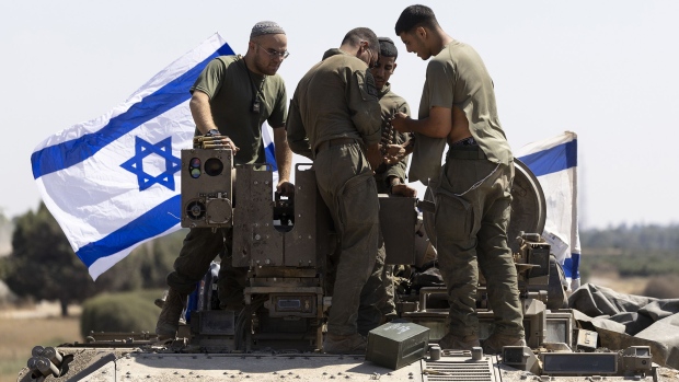 Israeli soldiers work with munitions on an armored personnel carrier near the border with the Gaza Strip on June 6, 2024. Photographer: Amir Levy/Getty Images Europe