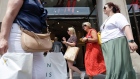 Shoppers pass an H&M store on Oxford Street in central London. Photographer: Carlos Jasso/Bloomberg
