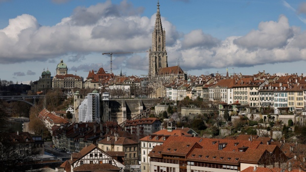 Residential and commercial properties surround the Bern Minster cathedral on the city skyline in Bern, Switzerland, on Monday, March 20, 2023. UBS Group AG shares slumped Monday as investors digested the news of its historic acquisition of rival Credit Suisse Group AG and began to assess the job of integrating the troubled Swiss lender. Photographer: Stefan Wermuth/Bloomberg