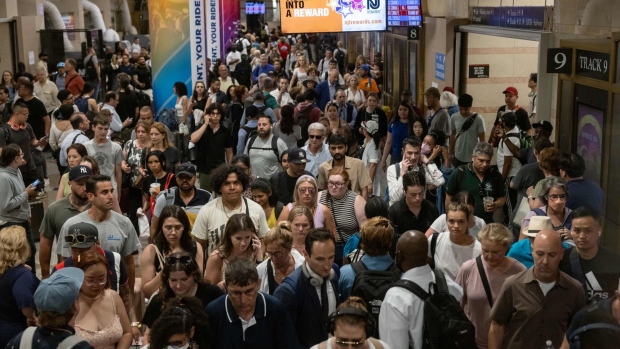 <p>Commuters at the New Jersey Transit train platform at Penn Station in New York in June.</p>