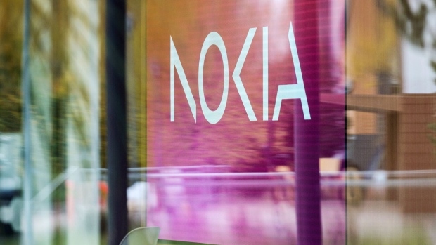 A logo in a window of the Nokia Oyj headquarters in Espoo, Finland, on Thursday, Oct. 19, 2023. Nokia Oyj plans to cut as many as 14,000 jobs, or 16% of its workforce, as a dearth of investment in fifth-generation mobile infrastructure forces it to take cost-cutting measures. Photographer: Roni Rekomaa/Bloomberg