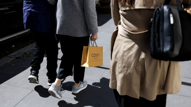 A pedestrian carries a Coin branded shopping bag in downtown Rome, Italy, on Tuesday March 28, 2023. Italy is due to report their latest inflation figures on Friday.