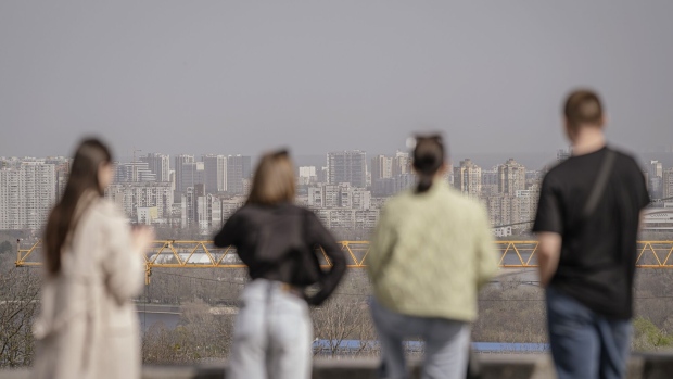 Pedestrians look across the city during air pollution from Saharan dust in Kyiv, Ukraine, on Tuesday, April 2, 2024. Dust caused by sand from the Sahara has increased the concentration of particles in the air in the Ukrainian capital. Photographer: Andrew Kravchenko/Bloomberg