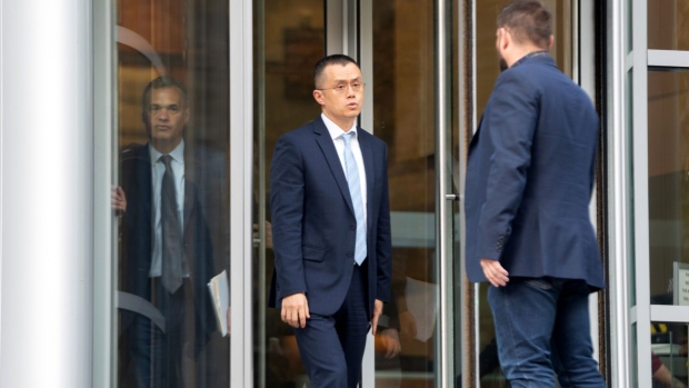 Changpeng Zhao, center, exits federal court in Seattle on Nov. 21.