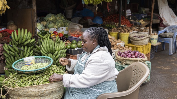 <p>A vendor sorts green beans in her store at a market in Nairobi.</p>