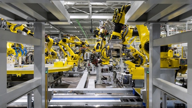 Hyundai Wia Corp. robotic arms on the production line at the Kia Corp. plant in Gwangmyeong, South Korea, on Wednesday, Jan. 3, 2024. Hyundai Motor Group, which controls the Hyundai, Kia and Genesis brands, plans to boost annual output of electrical vehicles in Korea to 1.51 million cars by the end of this decade, or about 40% of the group's estimated global EV production of 3.64 million vehicles. Photographer: SeongJoon Cho/Bloomberg