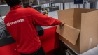A worker packs a customer's order inside a DB Schenker logistics hub near Gothenburg, Sweden, on Wednesday, March 20, 2024. Deutsche Bahn AG started the sales process for its DB Schenker logistics unit, which could be valued at as much as €20 billion ($21.3 billion), to a financial investor or rival logistics company.