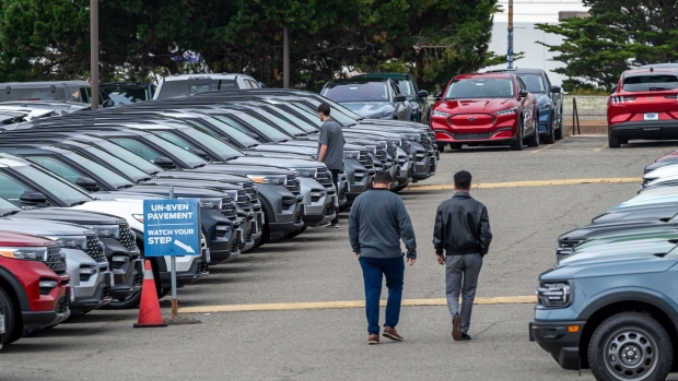 Customers view used Ford vehicles at a dealership in Colma, California, US, on Friday, June 21, 2024. CDK Global, a software provider to some 15,000 car dealers, was waylaid by debilitating cyberattacks this week that have had a crippling effect on the auto sales industry. Photographer: David Paul Morris/Bloomberg
