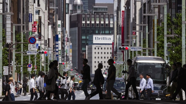 Pedestrians cross a road in the Ginza shopping district of Tokyo. Photographer: Toru Hanai/Bloomberg