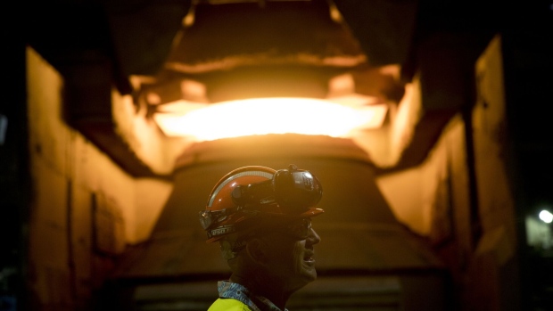 <p>An employee in front of a steel furnace at BlueScope Steel Ltd. Port Kembla steelworks in Australia. </p>