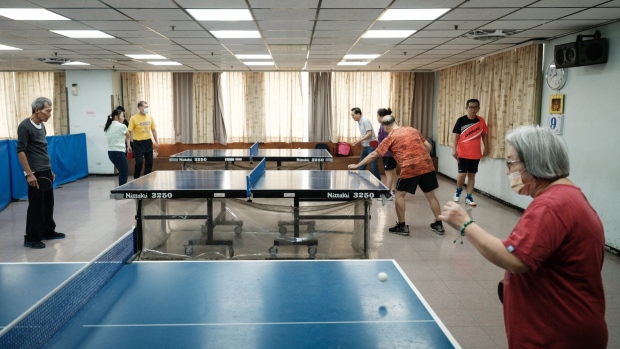 Elderly people playing table tennis at the city's social service centre in Kaohsiung, Taiwan. Photographer: Yasuyoshi Chiba/AFP/Getty Images