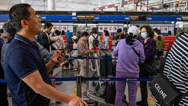 <p>Travelers at Beijing Capital International Airport.</p>