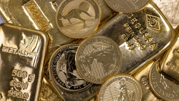 <p>A selection of gold bars and one-ounce gold coins arranged at Gold Investments Ltd. bullion dealers in London, UK.</p>