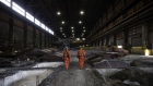 <p>Workers walk between cooling ingots at a copper smelting complex in Sudbury, Ontario.</p>